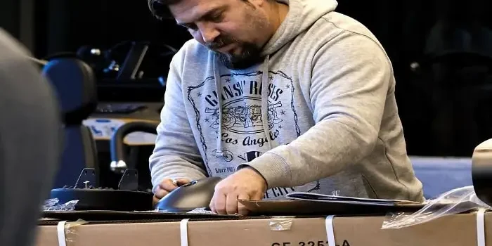 فردی در حال بازکردن کارتن دستگاه باشگاه